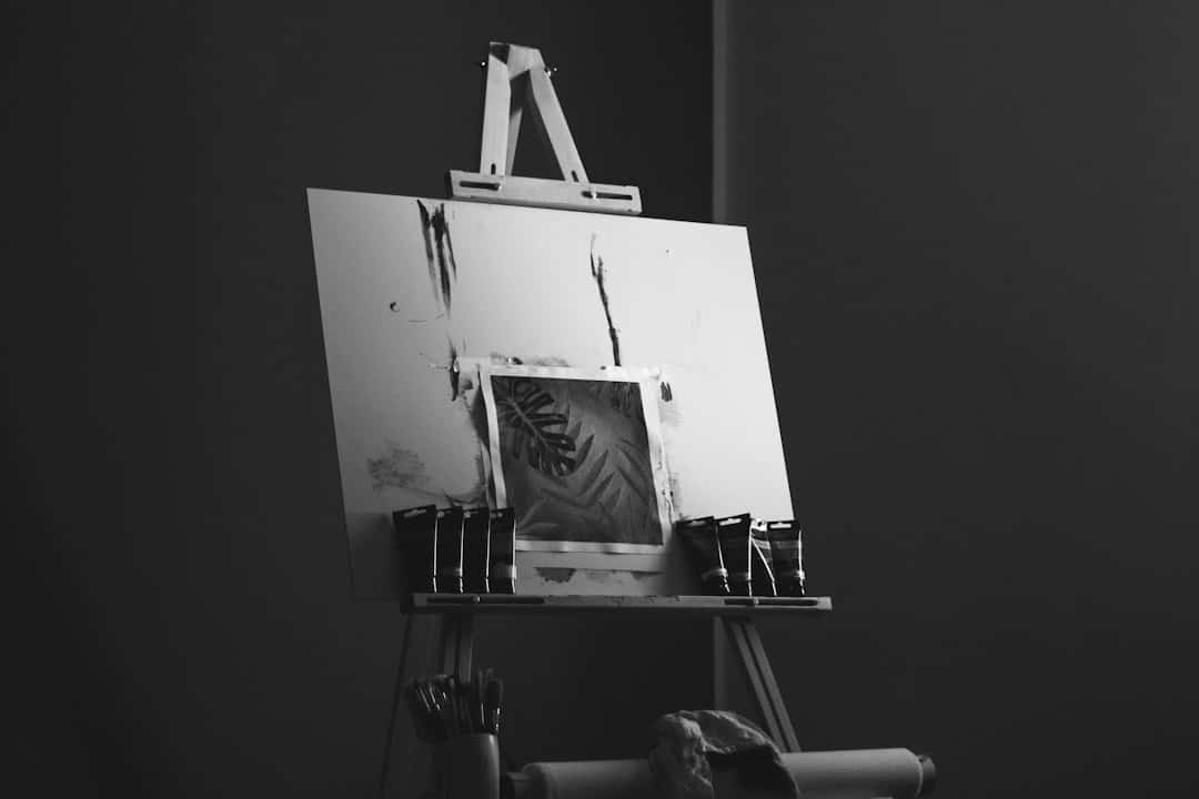 Wooden easel with botanical painting and art supplies.